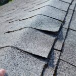 Lifted shingles on an asphalt shingle roof
